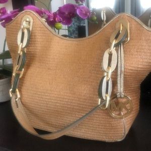 Michael Kors weaved bag with leather straps with Gold hardware.